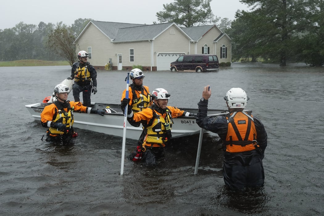 Members of the FEMA Urban Search and Rescue Task Force 4 from Oakland, California, search a flooded neighborhood for evacuees during Hurricane Florence in Fairfield Harbour, North Carolina.