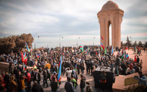 Azerbaijani people visit Alley of Martyrs, a cemetery and memorial dedicated to those killed by Soviet troops during the 1990 Black January, as they gather to celebrate the deal reached to halt fighting over the Nagorno-Karabakh region on November 10, 2020.