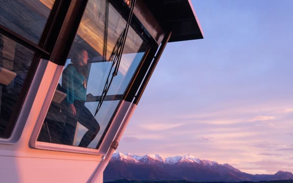 Sally Watson watching sunrise from the RV Tangaroa