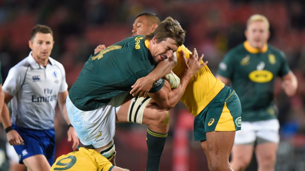 South Africas' Eben Etzebeth is tackled by Australia's Kurtley Beale during the 2019  Rugby Championship.