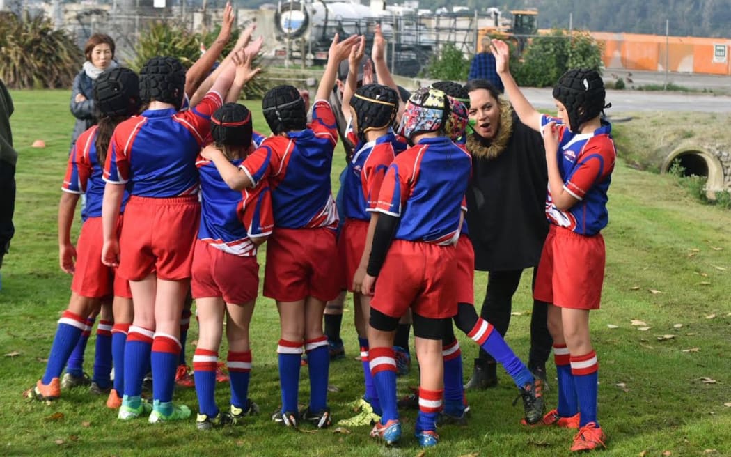 A Harbour junior rugby team celebrates at Moller Park.