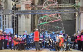 Woolston Brass band playing in the Christ Church Cathedral in front of the Christchurch City Mission Christmas tree. 