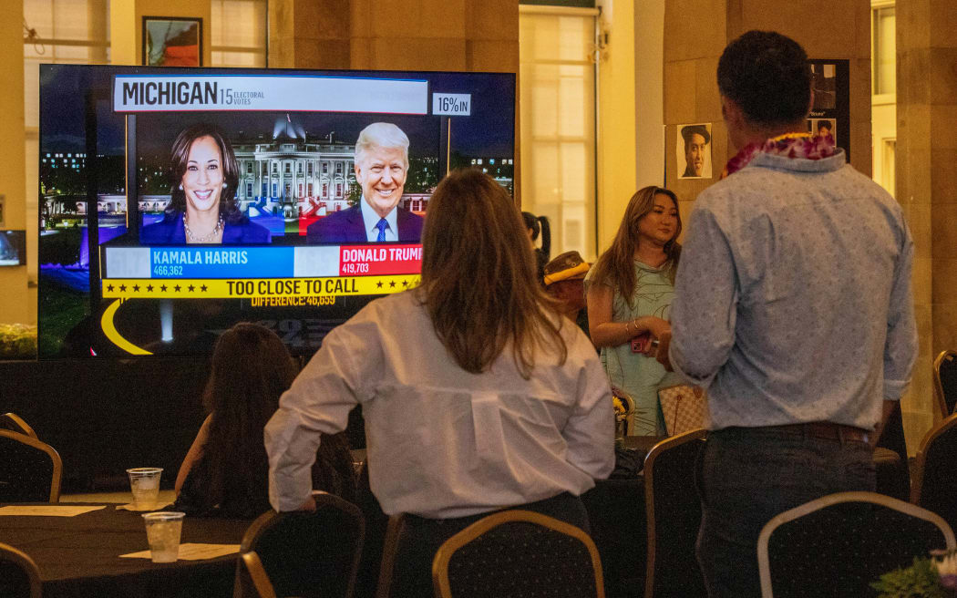 Members of Hawaii's Democratic Party watch some election results as they attend a watch party at the Inspiration Hawaii Museum in Honolulu, Hawaii, on November 5, 2024. - An estimated 250 members of the political party gathered to watch the results of the 2024 general election unfold. (Photo by Eugene TANNER / AFP)