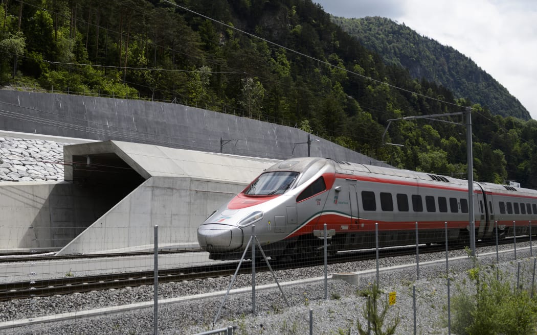 An Italian train makes its way at the north entrance of the new Gotthard Base Tunnel the world's longest train tunnel on the eve of its opening ceremony.