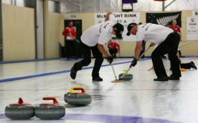 Anton Hood (left) and Warren Dobson sweep ahead of a New Zealand stone