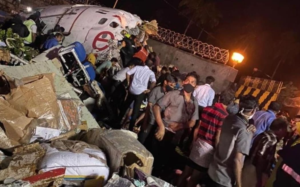 KERALA, INDIA - AUGUST 07: Teams conduct search and rescue operation at the site after an Air India Express passenger plane with 191 passengers onboard skidded off the runway in the southern Indian state of Kerala on August 07, 2020.