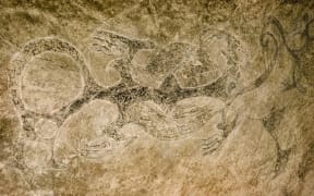 Ngāi Tahu rock art of three taniwha with their tails intertwined.