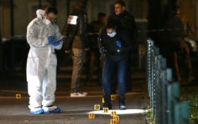 French forensic police work on the site of a knife attack where a man is suspected of killing one person and seriously wounding two police officers in Mulhouse, eastern France on February 22, 2025. Prosecutors said three more officers were lightly wounded in the attack in the city of Mulhouse, carried out by a 37-year-old suspect who is on a terror prevention watchlist, prosecutor told AFP. (Photo by SEBASTIEN BOZON / AFP)