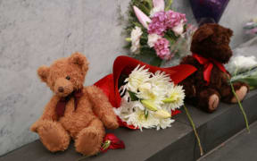 Flowers and toys were placed at the memorial for those who died.