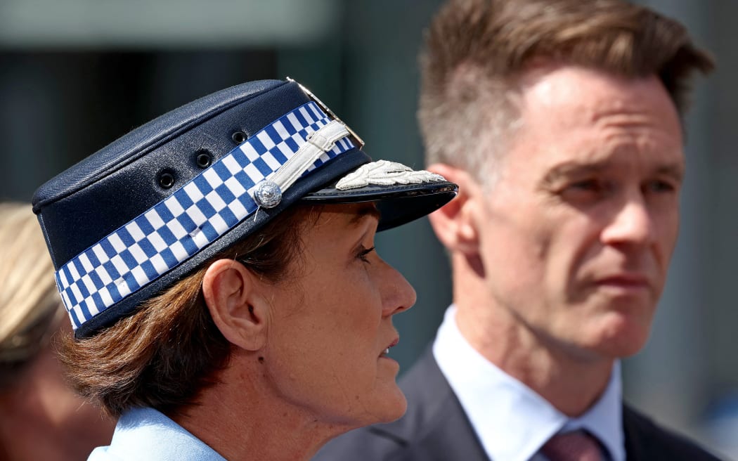 In this photo taken on April 14, 2024, New South Wales Premier Chris Minns (R) stands next to NSW police commissioner Karen Webb as she speak to the media outside the Westfield Bondi Junction shopping mall in Sydney, the day after a 40-year-old knifeman with mental illness roamed the packed shopping centre killing six people and seriously wounding a dozen others. (Photo by DAVID GRAY / AFP)