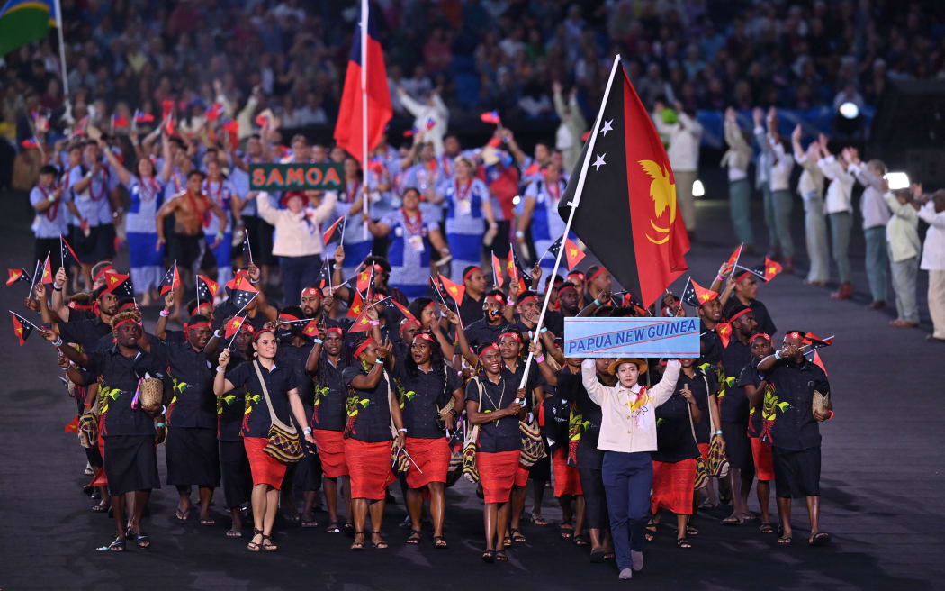 Papua New Guinea's flag bearers John Ume and Rellie Kaputin and teammates take part in the opening ceremony for the Commonwealth Games at the Alexander Stadium in Birmingham, central England, on July 28, 2022. (Photo by Glyn KIRK / AFP)