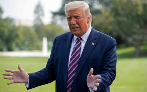 US President Donald Trump speaks to the press as he departs from the South Lawn the White House on 18 September.