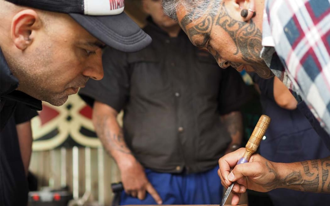 Toi Ngāpuhi expert Bernard Makoare explaining patterns to local carvers at a Whaiwhatawhata Marae wānanga funded by Creative New Zealand through the Te Awe Kōtuku programme.