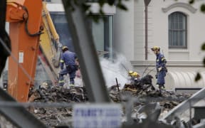Relief workers sift through the wreckage of the CTV building following the February 2011 earthquake in Christchurch.