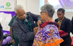Shamima Ali receiving her 40th Anniversary Medal, from Vanuatu President Nikenike Vurobaravu