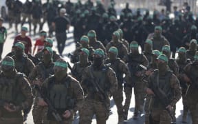 Fighters from the Ezz-Al Din Al-Qassam Brigades, the armed wing of the Palestinian Hamas movement, during an anti-Israel military show in Gaza City, on 20 July, 2022.