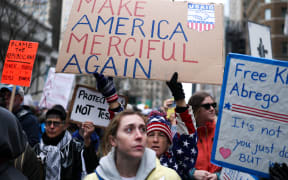 Demonstrators march during the nationwide 'Hands Off!' protest against US President Donald Trump and his advisor, Tesla CEO Elon Musk, in New York.