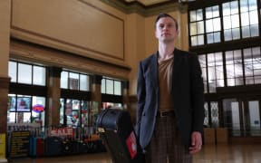 Anthony Tonnon waiting for the train on his Rail Lands tour