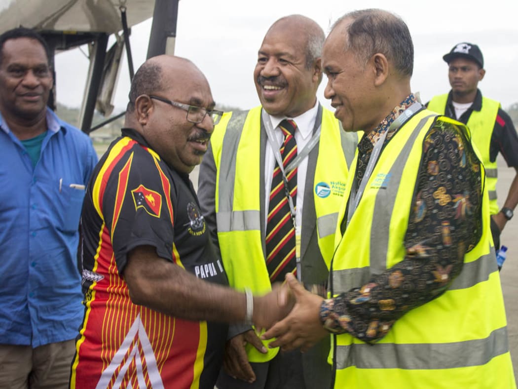 Governor Parkop welcoming his Indonesia's Papuan counterpart Lukas Enembe at the Jackson's International Airport.