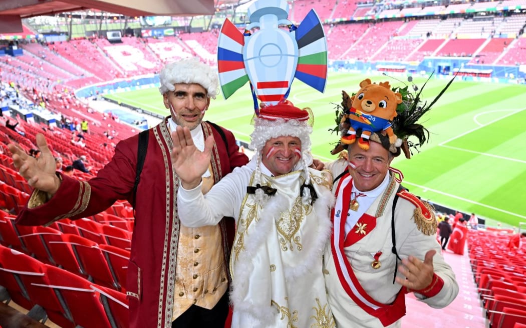 02 July 2024, Saxony, Leipzig: Soccer: European Championship, Austria - Turkey, final round, round of 16, Leipzig Stadium, three costumed Austrian fans in the stadium before the match. Photo: Hendrik Schmidt/dpa (Photo by HENDRIK SCHMIDT / DPA / dpa Picture-Alliance via AFP)