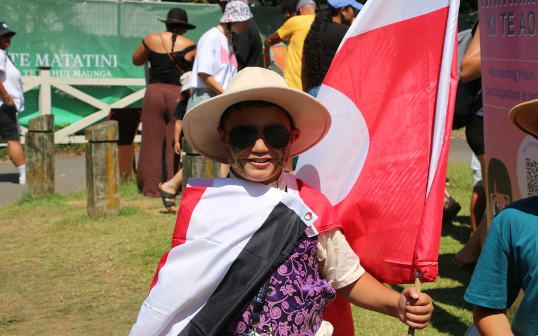 Tamariki tāne ‘Evo’ - known at Te Matatini o Te Kāhui Maunga, he said at 'Mr Flag man,' is repping the tino rangatiratanga kara proudly.