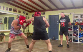 Jamie Cox (right) of Wairoa Boxing club reffing a sparring session