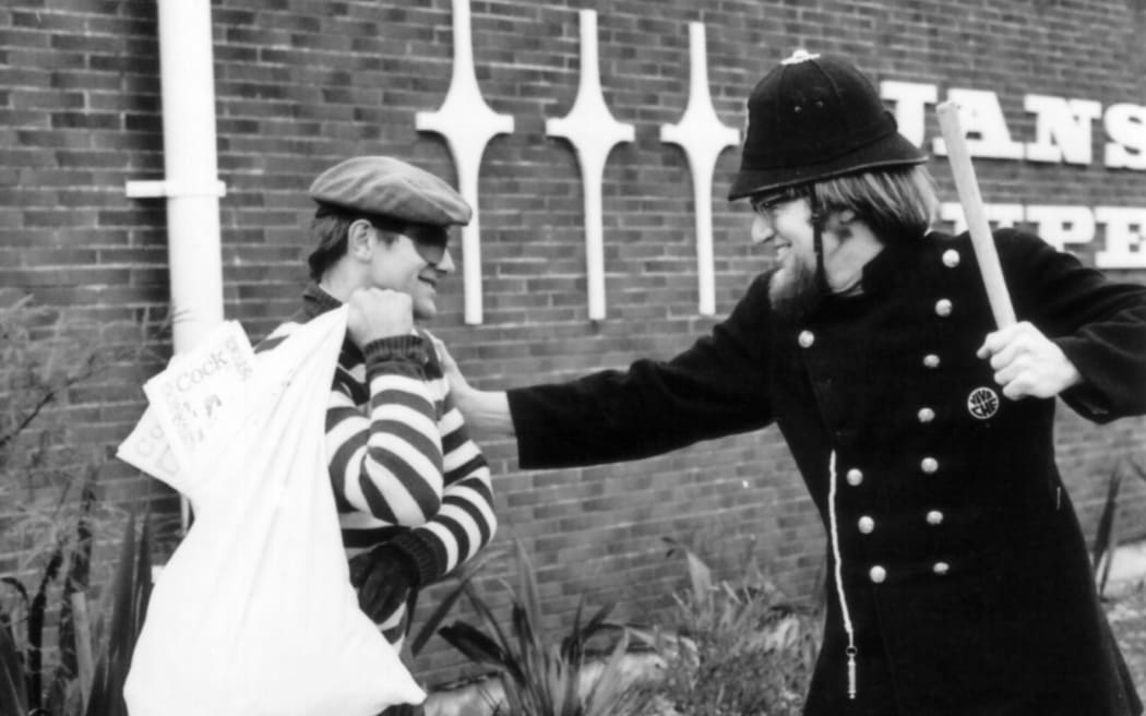 BLERTA actors Bruno Lawrence and Tony Barry ham it up in a keystone cops role, with the contents of the loot bag appearing to be copies of the controversial 70s underground magazine Cock.