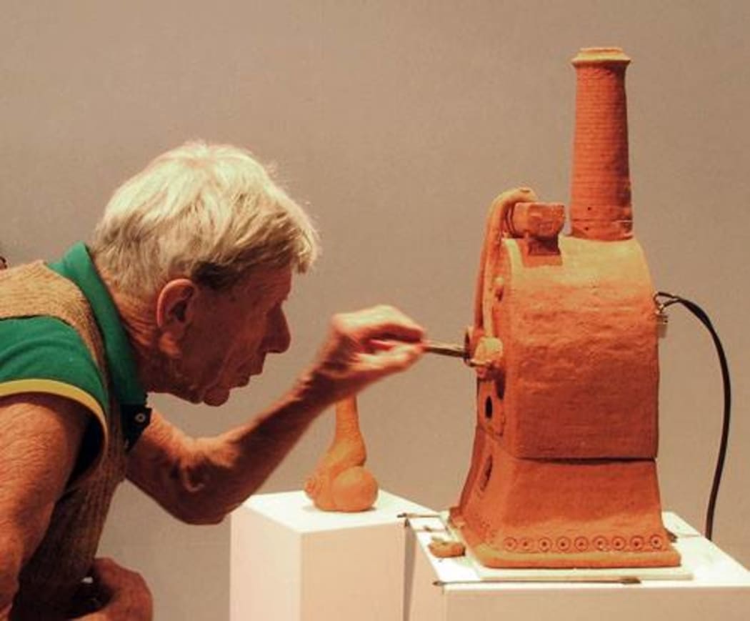 Barry Brickell stoking a miniature clay kiln at a Dunedin exhibition of his work.  https://www.facebook.com/photo.php?fbid=557468860973747