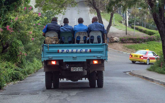 Police commute on a road as the close streets leading to Parliament house in Port Moresby on May 28, 2019. Papua New Guinea Prime Minister Peter O'Neill stalled his announced resignation and took legal action to prevent a vote of no confidence on May 28, deepening the country's political crisis. (Photo by Ness Kerton / AFP)