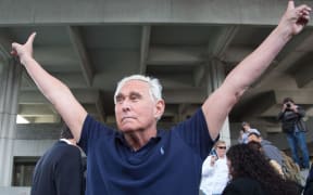 (FILES) In this file photo taken on January 25, 2019 Roger Stone, a longtime adviser to US President Donald Trump, throws up peace signs outside court in Fort Lauderdale, Florida.