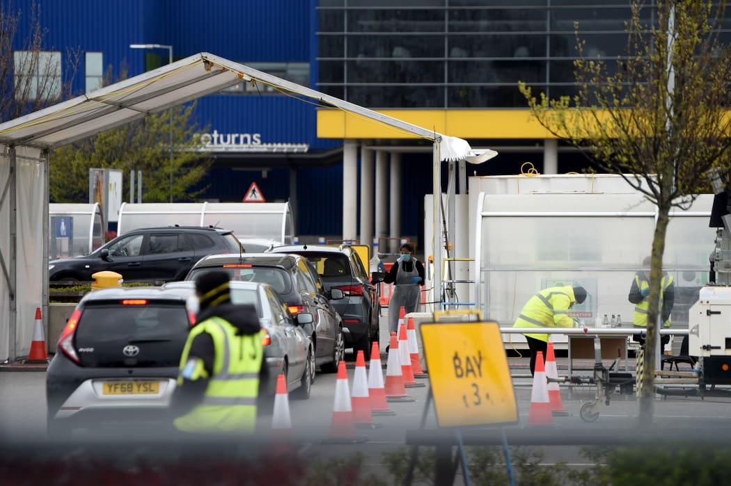 A long queue of cars wait at a coronavirus  drive-through testing station set up at the for NHS staff in London.