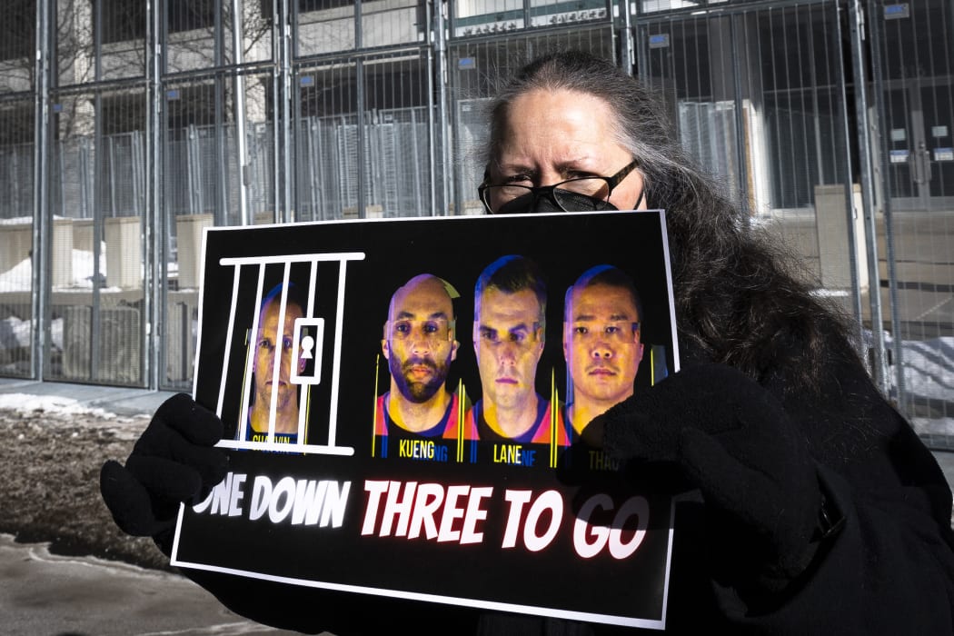 A community activist holding a sign outside the US District Court in St. Paul, Minnesota.