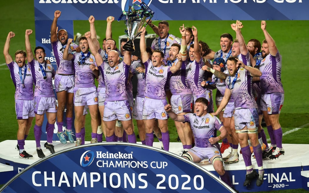 Exeter Chiefs players celebrate with the trophy on the pitch after the European Rugby Champions Cup final rugby union match between Exeter Chiefs and Racing 92 at Ashton Gate Stadium in Bristol, south-west England on October 17, 2020.