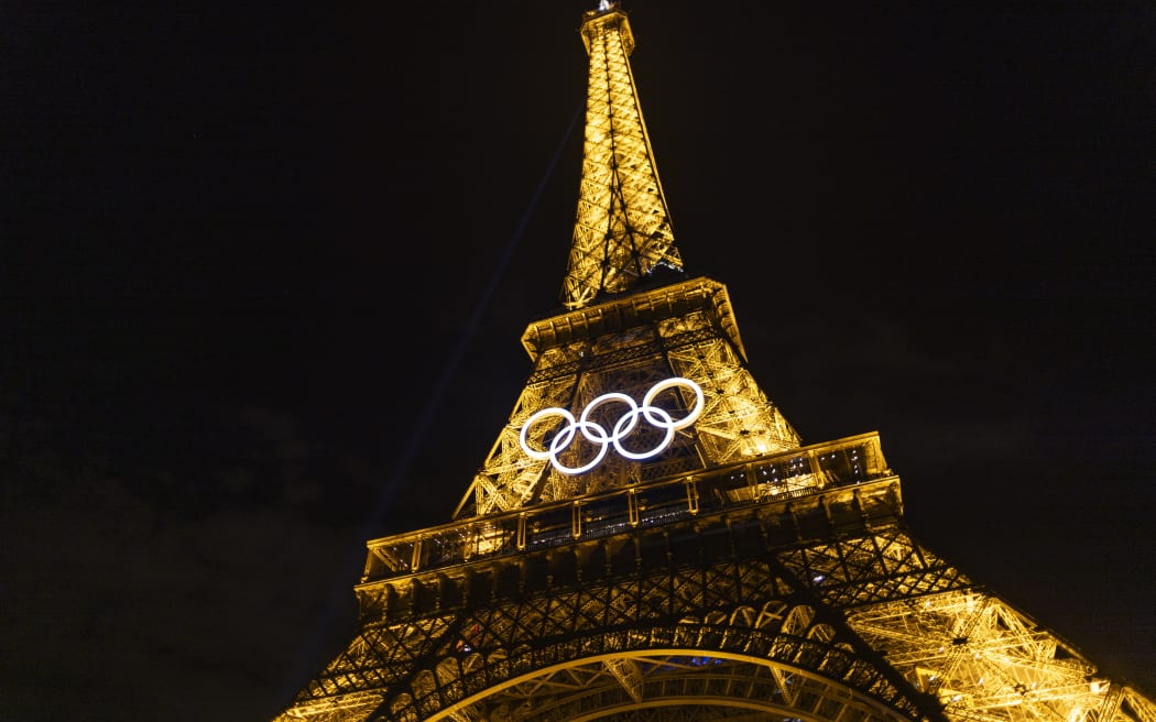 A general view of the Eiffel Tower at night as the Olympic Rings are displayed during previews ahead of the Paris 2024 Olympic Games.
