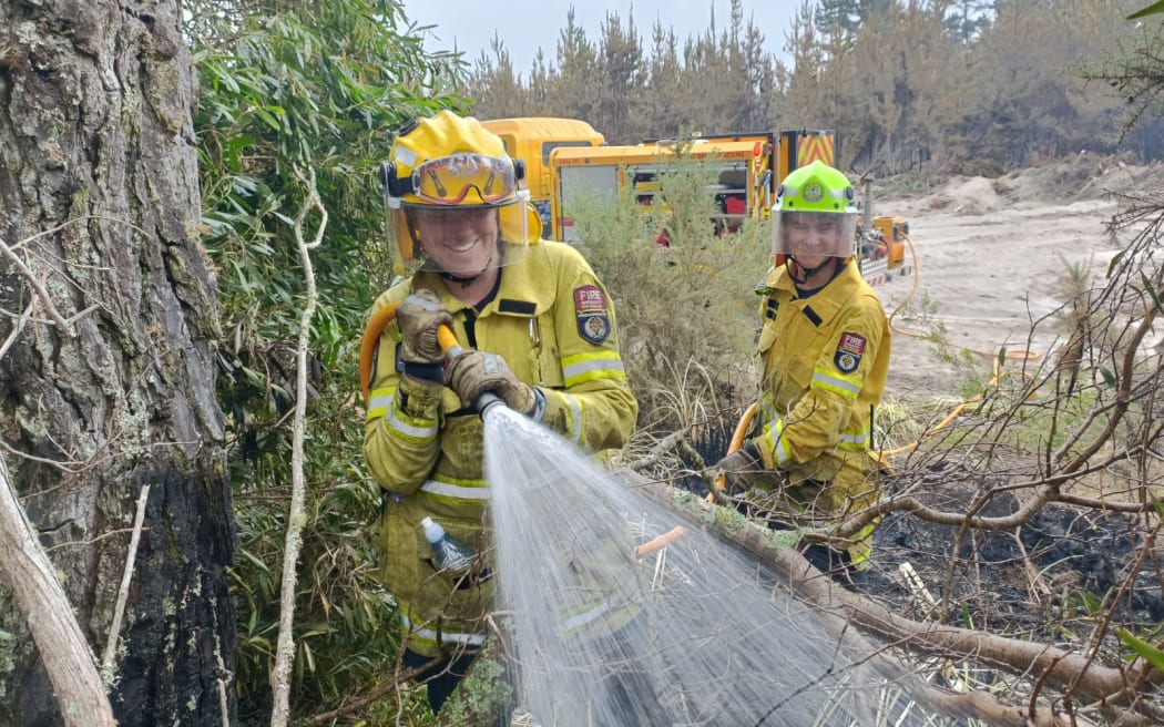 Rural Firefighters Ryan Pryde and Juliska Coetzee from the Eastern Bay Volunteer Fire Brigade at work on Matakana Island.