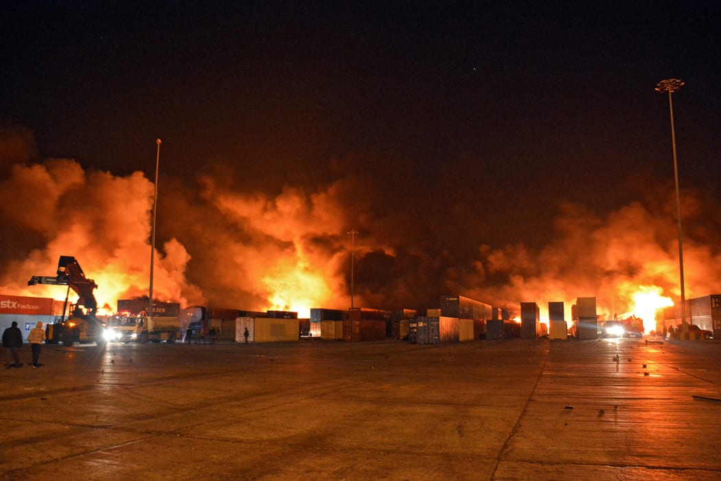 Firefighters battle the blaze at Syria's Latakia port after an Israeli air strike.
