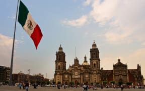 The Mexican flag flying near the cathedral in Mexico City.
