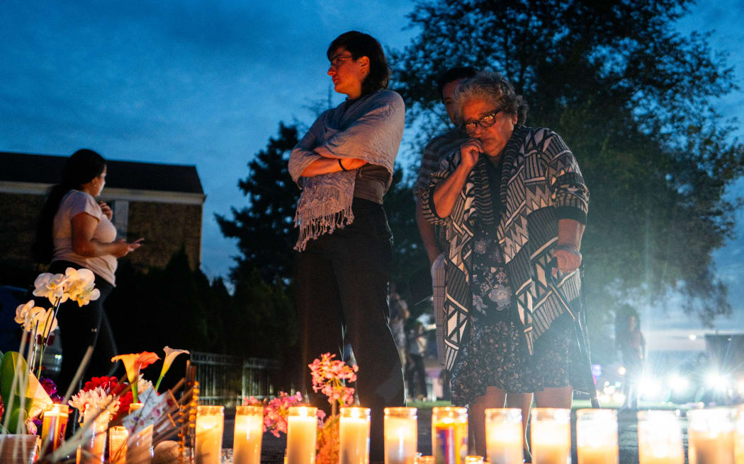 FRANKLIN PARK, ILLINOIS - SEPTEMBER 13: People pay their respects during a demonstration near a small memorial for Silverio Villegas-Gonzalez on September 13, 2025 in Franklin Park, Illinois. According to ICE, Villegas-Gonzalez was shot after he dragged an ICE agent with his car while fleeing. The Chicago area has seen a surge in ICE activity recently, part of the Trump administration's crackdown on undocumented immigrants in the area dubbed Operation Midway Blitz.   Brandon Bell/Getty Images/AFP (Photo by Brandon Bell / GETTY IMAGES NORTH AMERICA / Getty Images via AFP)