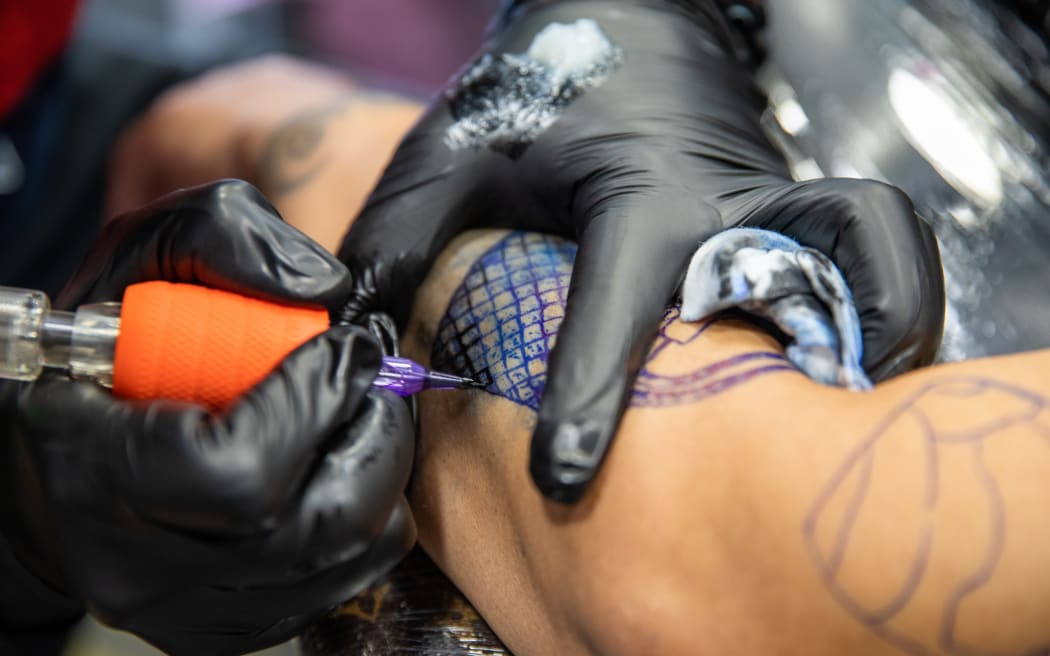Leroy Roberts of Maia Ink tattooing a client