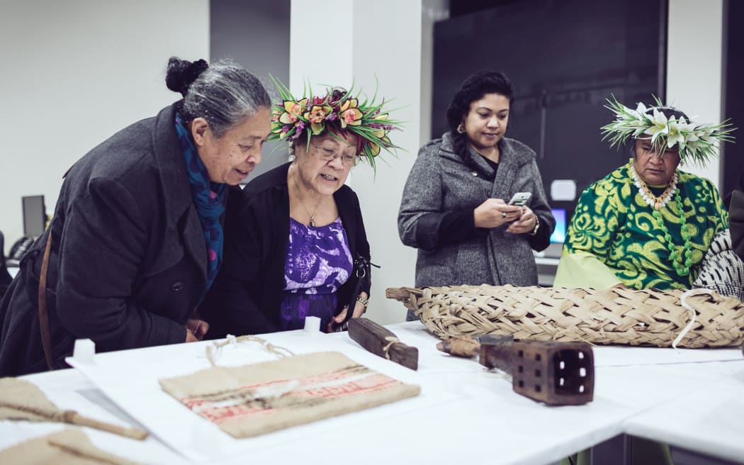Members of the Cook Islands community look at Auckland Museum's extensive collection, which is being brought out as part of a new project.