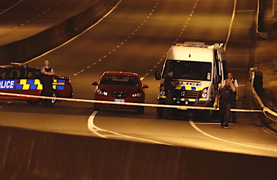 Police officers at the scene of the shootout last night.