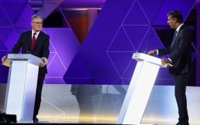 Britain's Prime Minister and Conservative Party leader Rishi Sunak, and Labour Party leader Keir Starmer attend a live TV debate, hosted by The BBC, in Nottingham, on June 26, 2024, in the build-up to the UK general election on July 4. (Photo by Phil Noble / POOL / AFP)