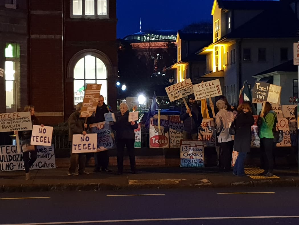 Protesters opposing a proposed chicken farm near Dargaville hold placards and chant outside a hui held by Tegel in Auckland on Wednesday 6 June 2018.