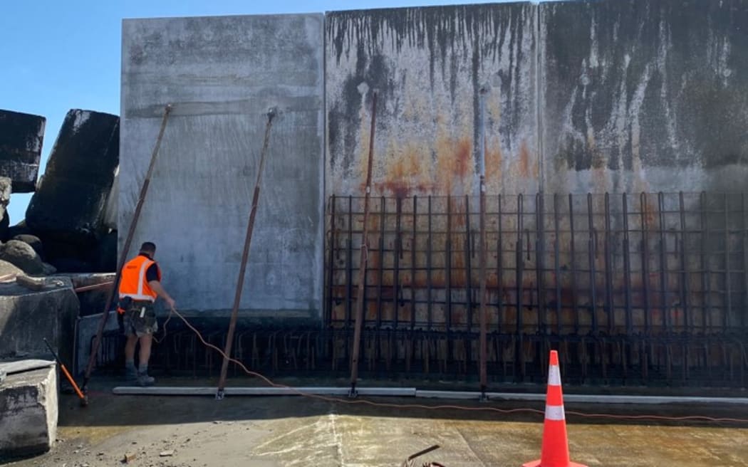 The first replacement panel – the first panel of the Main Breakwater wave wall – is put in place.