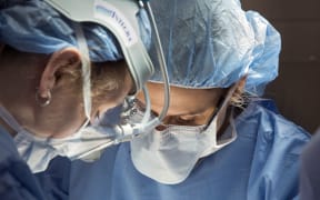Surgeons operating.