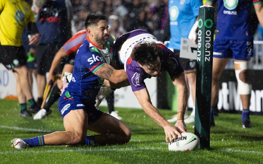 Melbourne Storm's Grant Anderson scores a try against the Warriors.