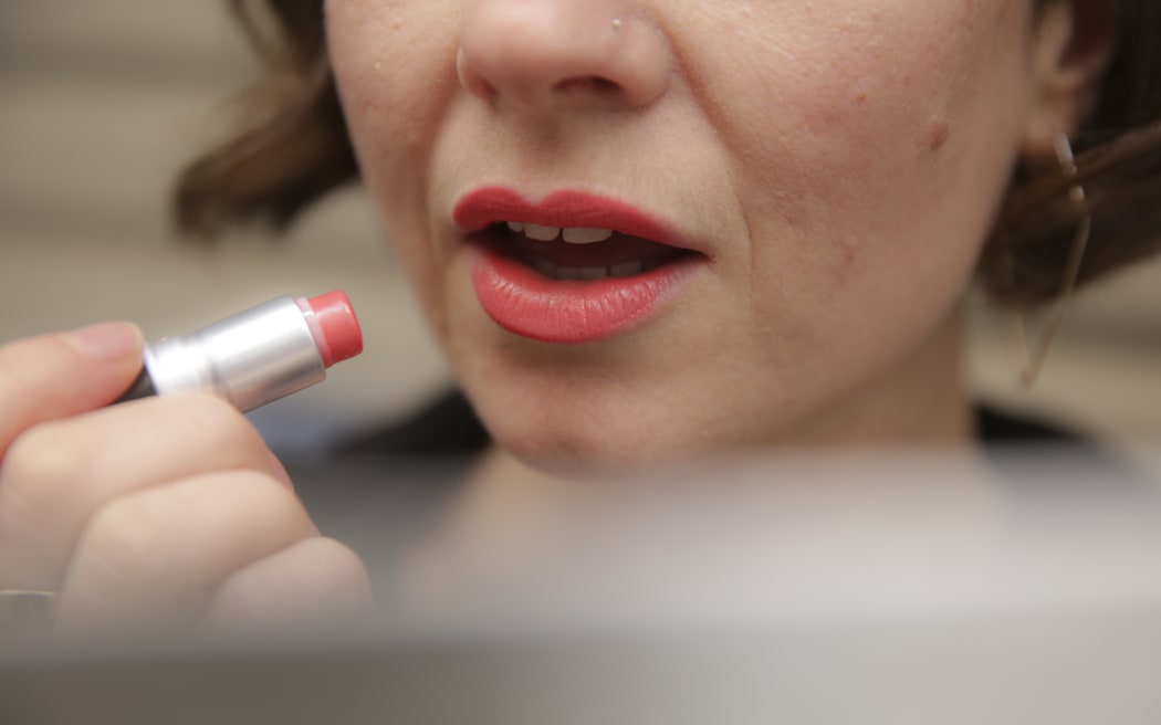 Applying lipstick