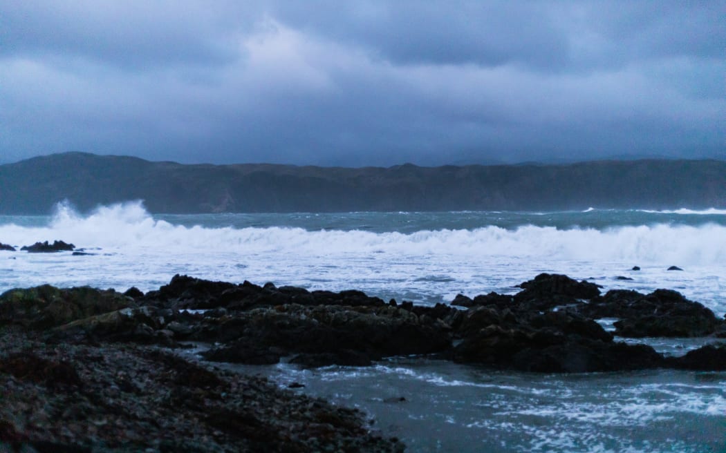 Waves break on Breaker Bay this evening as the size of the swell increases.