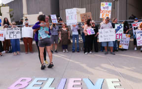 LONDON, CANADA - JULY 24: Supporters for 'E.M' gather outside a London Courthouse, in London, Ontario, Canada on July 24, 2025. Former world junior hockey players Dillon Dubé, Cal Foote, Alex Formenton, Carter Hart and Michael McLeod, have all pleaded not guilty to the sexual assault of a woman known as 'E.M' due to publication ban on her identity, that allegedly occurred at a London hotel in June 2018 as the team was celebrating their world championship win months earlier.   Cole Burston/Getty Images/AFP (Photo by Cole Burston / GETTY IMAGES NORTH AMERICA / Getty Images via AFP)