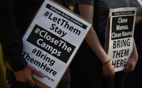 Refugee supporters hold placards as they gather in Sydney to mark the milestone of 200 days of continuous protests in the detention camp on the Pacific island of Nauru in 2016.